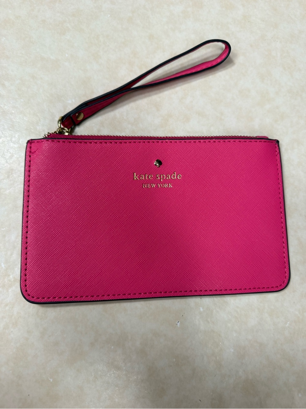 Bright pink Kate Spade New York Cedar Street Slim Bee wristlet